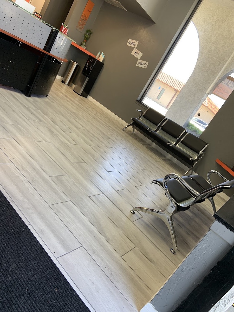 The customer waiting room at Palmdale Auto Services with bench seating and coffee